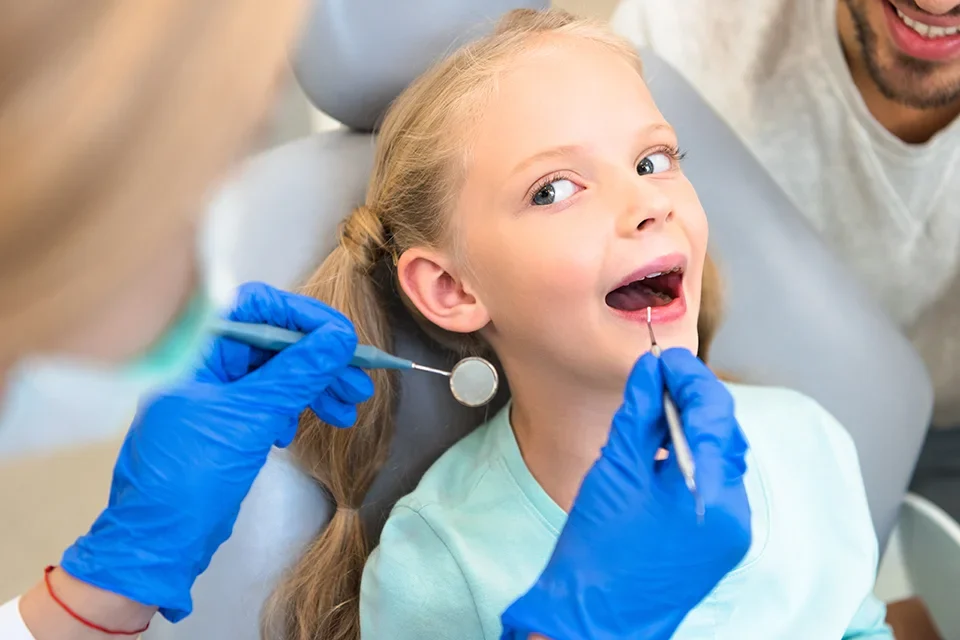 A family receiving dental treatment, including a young girl, at Family Dentistry