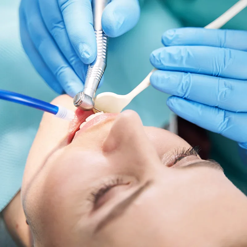 A woman receiving a dental check-up from an Emergency Dentist