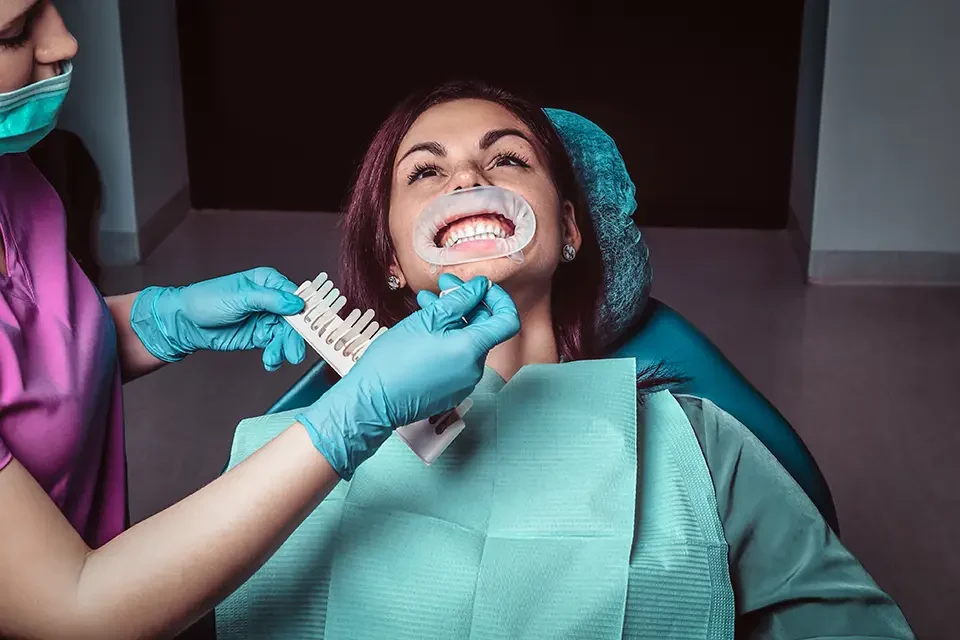 a-woman-dentist-checks-the-level-of-teeth-whitening Why is Shaving Teeth for Veneers Necessary?