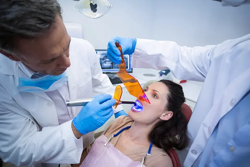 dentists-examining-female-patient Benefits of Visiting a Teeth Bleaching Dentist