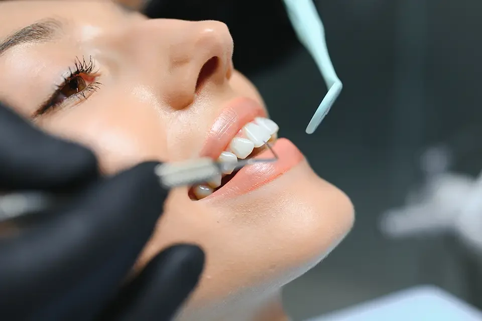 doctor-examining-patient-s-teeth-closeup-cosmetic Permanent Porcelain Veneers Cost in Richmond Hill