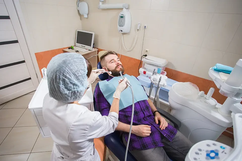 female-dentist-with-male-patient-at-clinic Preventing Toothache After a Root Canal
