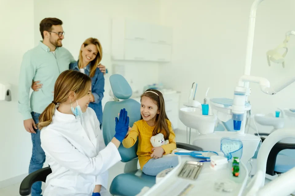 female-doctor-is-giving-hi-five-to-little-girl Benefits of Comprehensive Family Dental Care