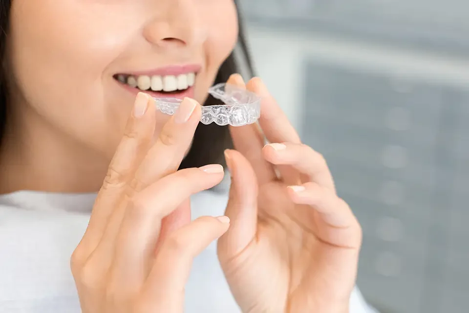 girl-holding-invisible-braces-moder-teeth-trainer Invisalign or Braces: Small Choices That Trim Weeks