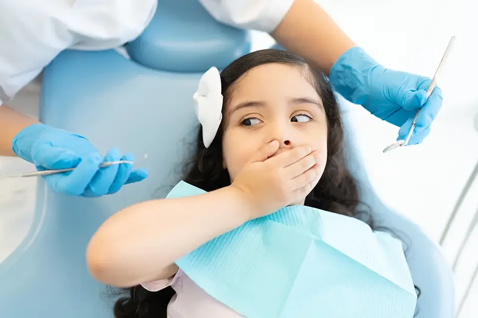 girl-scared-during-checkup-at-dental-clinic Common Emergency Dental Situations Families Face