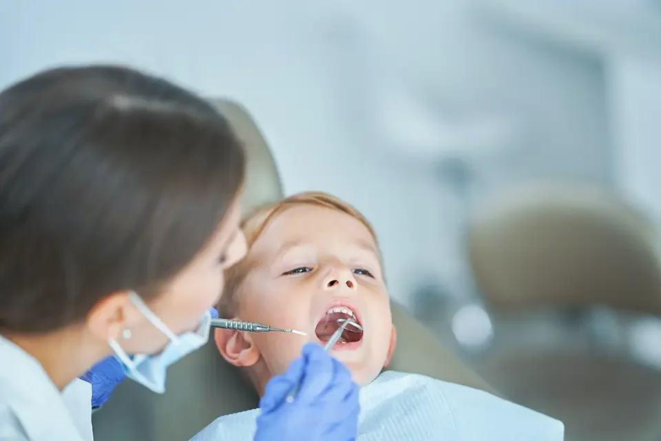little-boy-and-female-dentist-in-the-dentists-office What Happens During a 6 Month Dental Checkup?