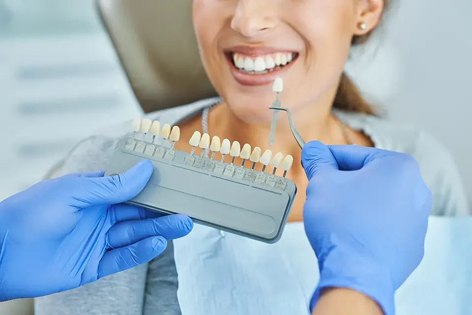 male-dentist-and-woman-choosing-tooth-shade Who is a Good Candidate for Ceramic Veneers?