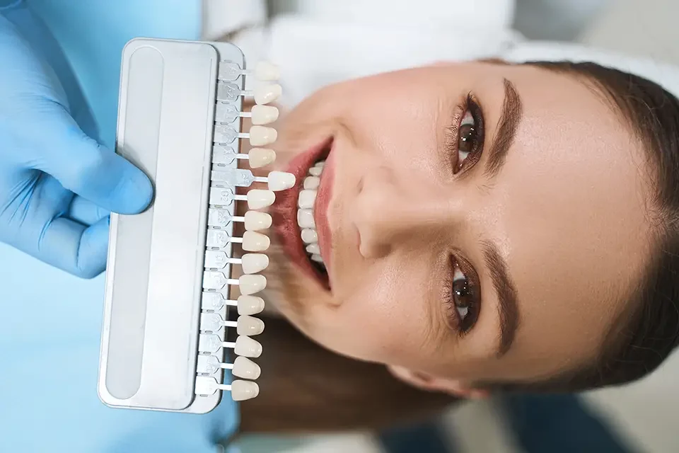 smiling-woman-is-choosing-veneers Understanding Veneer Teeth: What Are They?
