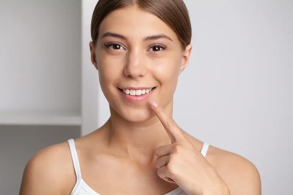 woman-with-strong-white-teeth-looking-at-camera How Can You Replace a Missing Tooth: Decision Guide That Matches Real Life