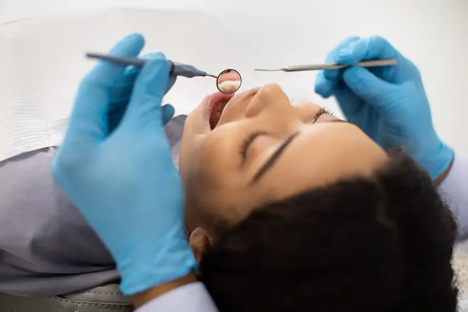young-black-female-patient-lying-in-chair Main Causes of Gum Recession